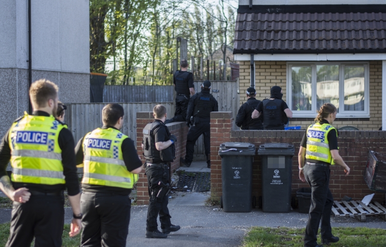 Armed police swarm Swindon street as police helicopter hovers overhead