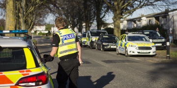 Armed police swarm Swindon street as police helicopter hovers overhead