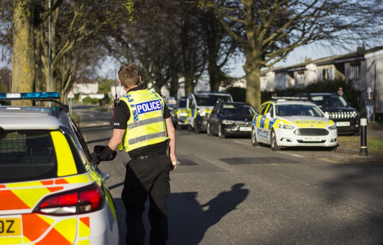 Armed police swarm Swindon street as police helicopter hovers overhead