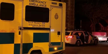 Unconscious woman found on church bench rushed to hospital in back of police car