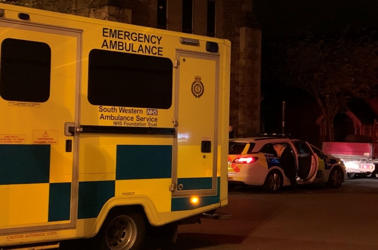 Unconscious woman found on church bench rushed to hospital in back of police car