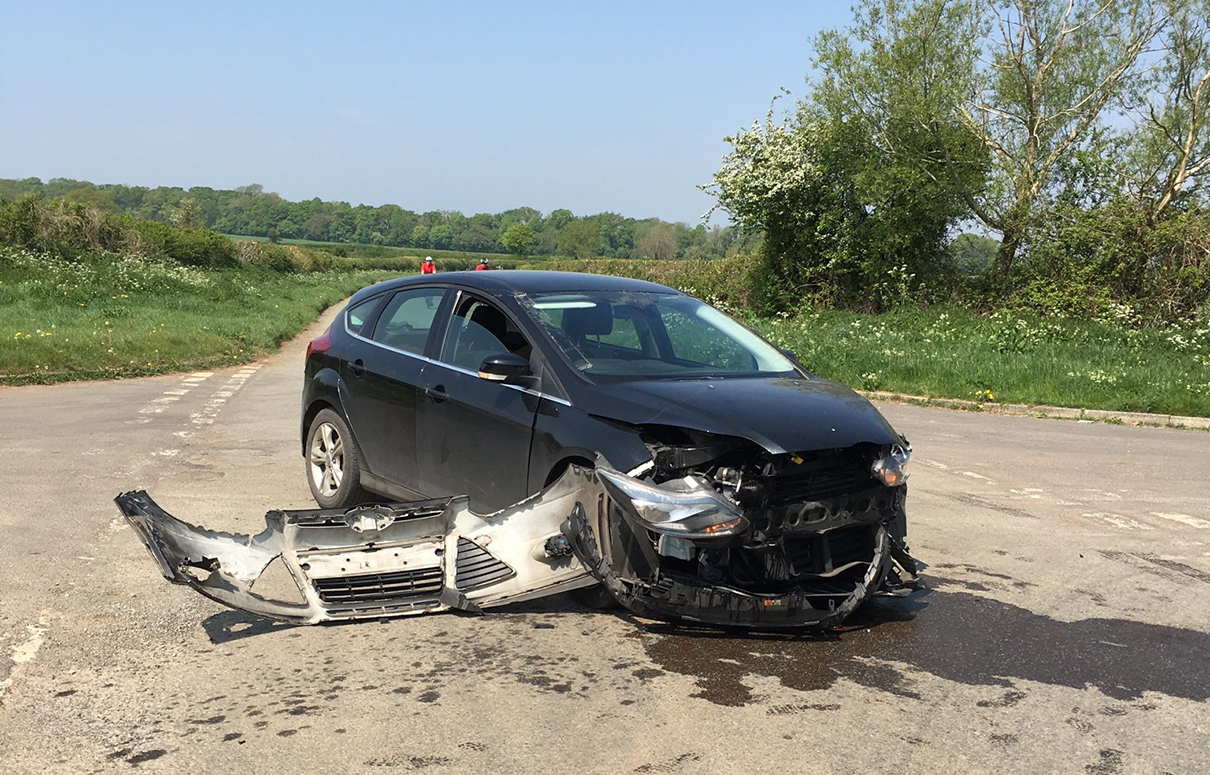 Road partially blocked after crash on countryside crossroads near
