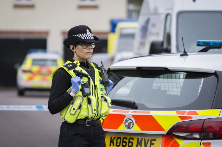 Road cordoned off as crime scene as detectives investigate death of woman