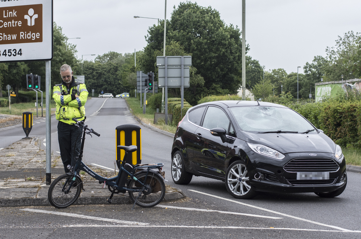 Pensioner on bicycle thrown across roundabout after being struck by car