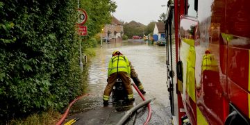 Six fire crews work to save locals’ possessions as dozens of homes flooded