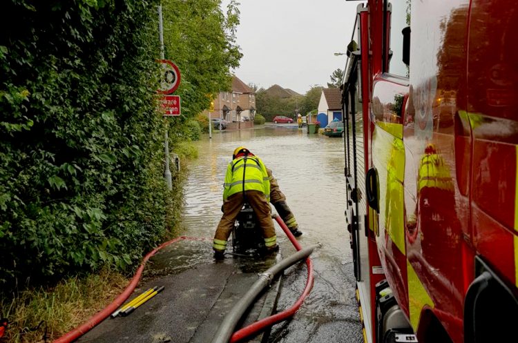 Six fire crews work to save locals’ possessions as dozens of homes flooded