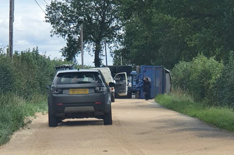 Crash involving tractor and overturned trailer blocks B4040 in both directions