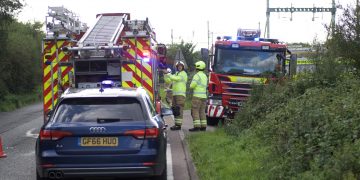 A420 partially blocked as fire crews battle blaze in building near railway