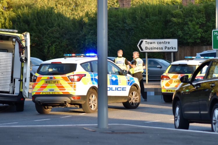 Police and ambulance at scene of motorcycle crash on roundabout in Melksham