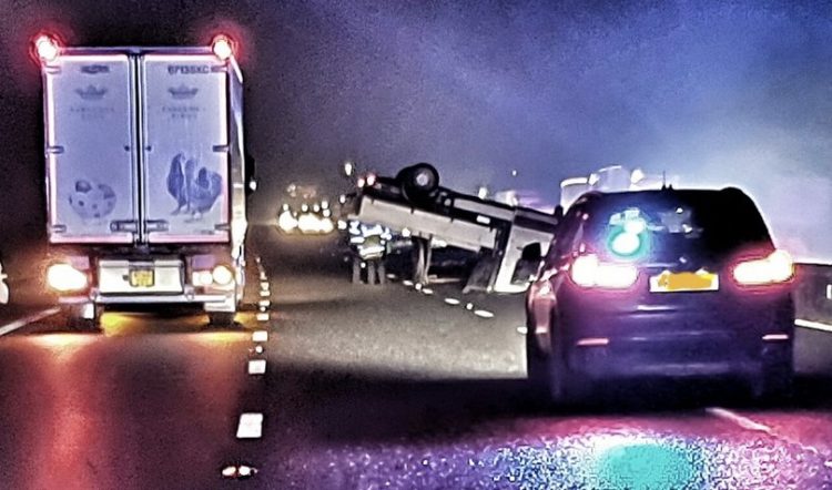 Manhunt after driver ditches overturned van in middle of pitch-black motorway