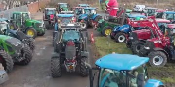 Eagle-eyed police spot woman filming charity tractor procession whilst driving