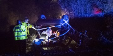 Car veers off A350 before crashing through hedge and overturning in field