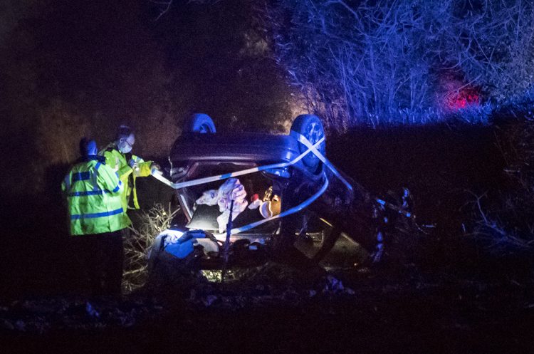 Car veers off A350 before crashing through hedge and overturning in field