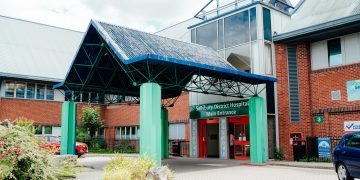Hospital suspends visiting as it struggles to cope with influx of COVID-19 patients