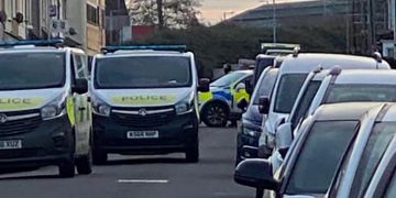 Police swarm residential street in Swindon closing it in both directions