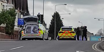 Police close central Swindon road as armed officers descend on house