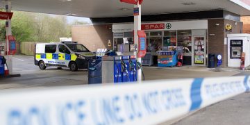 Crime scene at Esso service station following gunpoint robbery