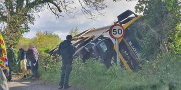 Road closed after M J Church lorry overturns in roadside ditch