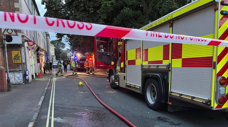 Police guard building after fire ripped through bedsit above Trowbridge shop