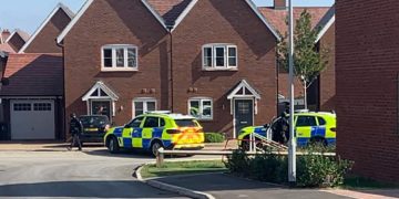 Armed police in Tadpole Garden Village as force hunts wanted suspect