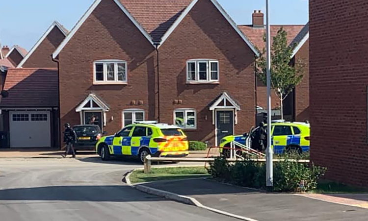 Armed police in Tadpole Garden Village as force hunts wanted suspect