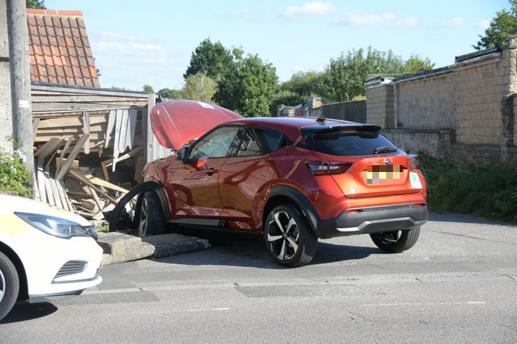 Police close road after car ploughs through garden fence in Trowbridge