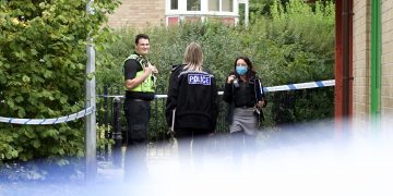 Detectives investigate gun discovery — crime scene outside dental practice