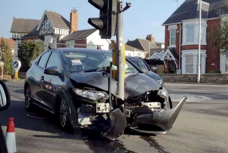 Traffic light remains upright after being wiped out by car and dragged 50 metres