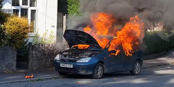 WATCH: Woman and dog narrowly escape inferno after car’s CD player bursts into flames