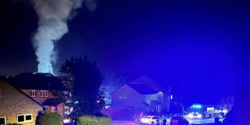 Four fire crews tackle flames at flats in Swindon – as smoke billows out of roof