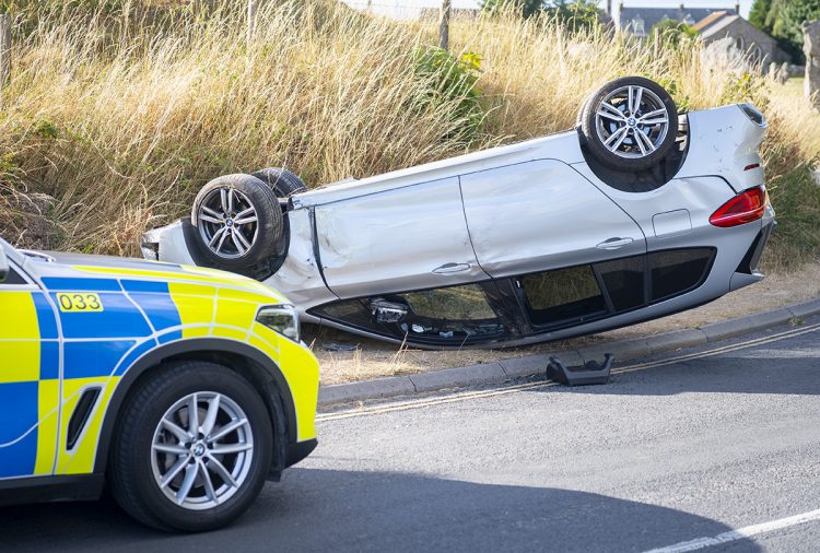 Car flips onto roof in crash on Wiltshire road as emergency services rush to scene