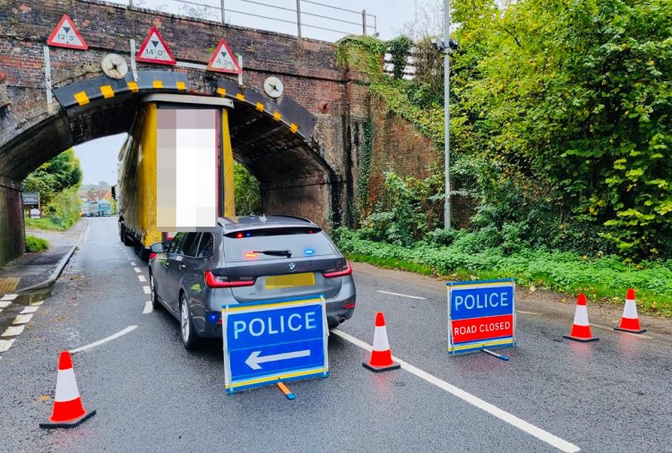 Driver ‘reported for careless driving’ after lorry strikes railway bridge on A36