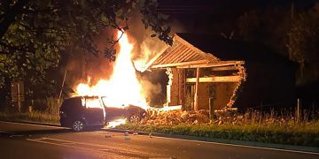 Driver taken to hospital after car ploughs into building and bursts into flames