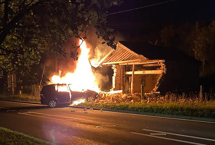 Driver taken to hospital after car ploughs into building and bursts into flames