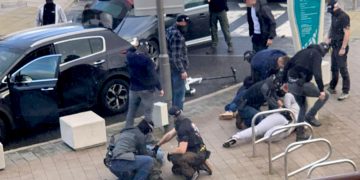Undercover armed cops swoop on trio as police simultaneously raid apartment