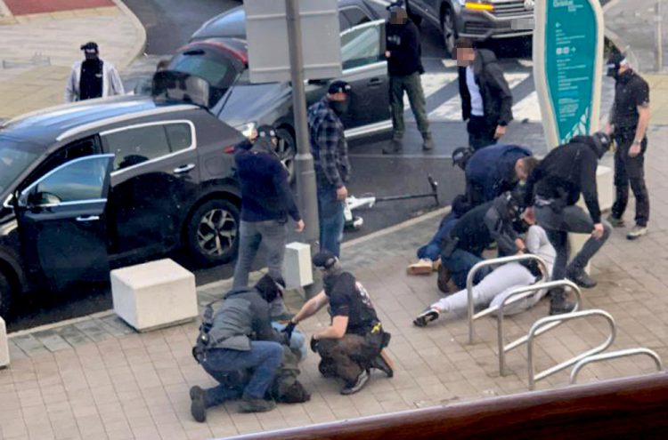 Undercover armed cops swoop on trio as police simultaneously raid apartment