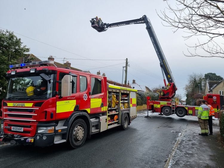 Firefighters tackle flames coming from chimney at house in Calne