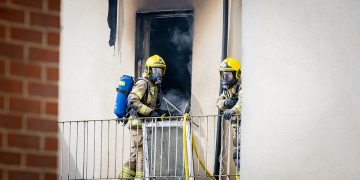 Firefighters tackle blaze at Swindon B&B as police close central route