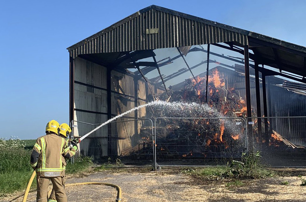 Firefighters tackle blaze in farmer's barn as tonnes of hay goes up in flames 