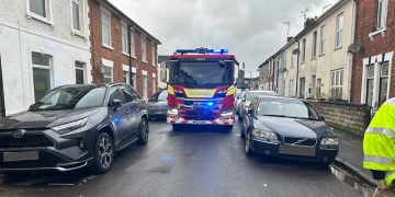 Fire engine responding to emergency call blocked by parked cars