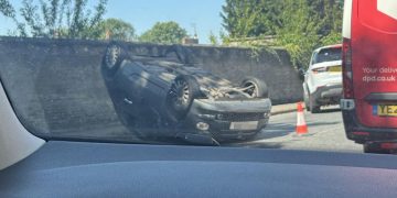 Car crashes and overturns on road near Wilton shopping village