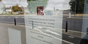 Businesses in Swindon close as armed police patrol over riot risk