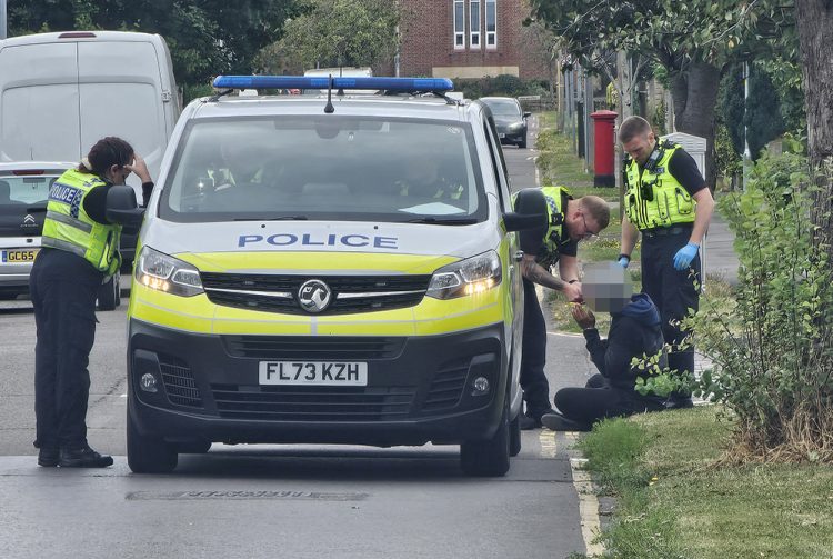 Police officers swarm Swindon street as suspect male arrested