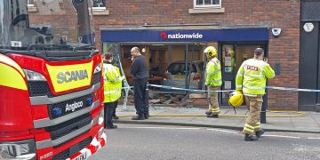 Driver hospitalised after smashing car through Nationwide’s window