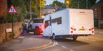 Car towing caravan crashes into garden wall in Chippenham
