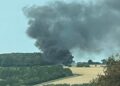 Combine harvester bursts into flames creating huge smoke plume