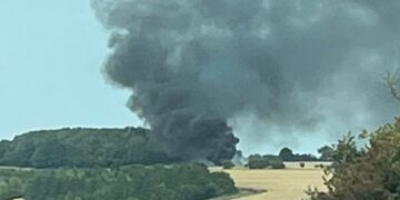 Combine harvester bursts into flames creating huge smoke plume