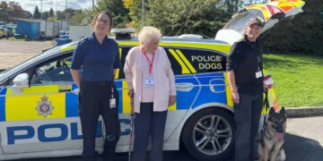Hazel Bush with police officers next to a patrol car