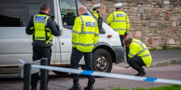 Elderly man knocked down by van outside shop fighting for his life