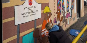 Artwork being painted on to the wall of toilets